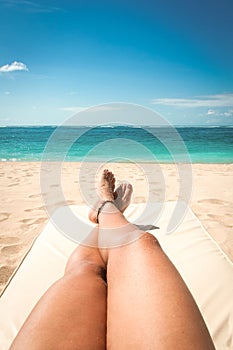 Young woman sunbathing on the beach