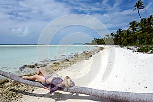 Young, woman sunbathing on deserted tropical island