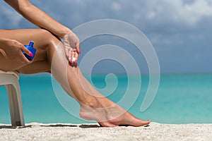 Young woman sunbathing on lounger. Legs.