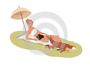 Young woman sunbathing in nature, relaxing together with dog. Happy girl, pet owner in bikini lying on blanket under