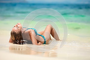 Young Woman Sunbathing At Tropical Beach