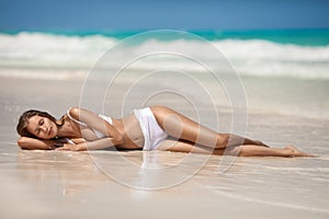 Young Woman Sunbathing At Tropical Beach