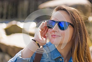 Young woman, sunglasses, slight smile... photo