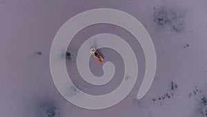 Young woman in sunglasses sunbathes lying on an air mattress. girl swims in a sunny pink lake. view from above.