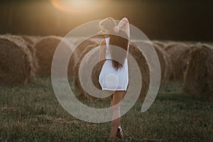 Young woman on sunrise field