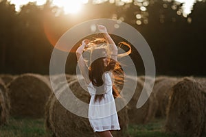 Young woman on sunrise field