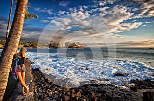 Young Woman at sunset on Kailua Kona coast in Hawaii