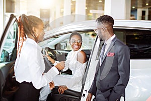 Young woman surprised by new car, gift for my beautiful wife