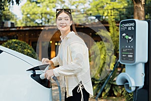 Young woman and sustainable urban commute with EV at cafe. Expedient photo