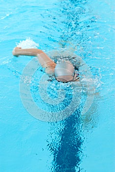 Young woman swim on indoor pool. freestyle mode.