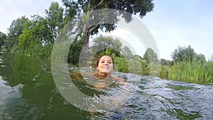 Young woman swimming in the lake in slow motion. 1920x1080