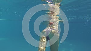 Young woman swimming in pool