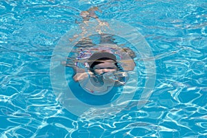 Young woman swimming in a pool