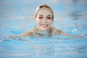 Young Woman Swimming In Pool