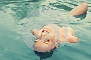 Young woman swimming tint photo