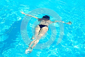 Young Woman Swimming Underwater in Swimming Pool. Summer Vacation