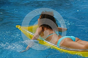 Young woman swimming in water pool