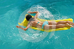 Young woman swimming in water pool