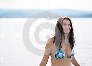 Young woman swims in the lake