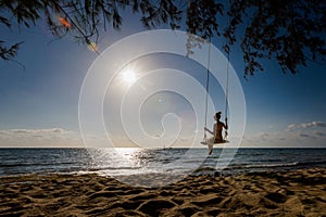 Young woman on swing in tropical Vietnam