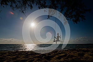 Young woman on swing in tropical Vietnam