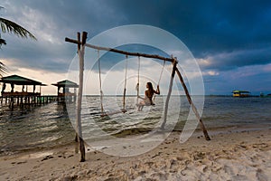Young woman on swing in tropical Vietnam