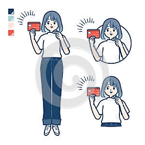 A young woman in a T-shirt with pointing at credit card images