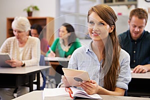 Young woman with tablet computer at an adult education class photo