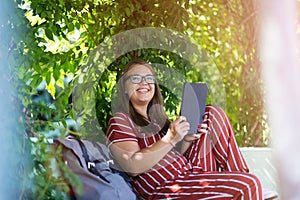 Young woman with tablet computer in the park