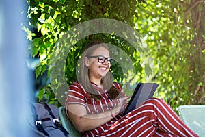 Young woman with tablet computer in the park