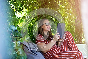 Young woman with tablet computer in the park