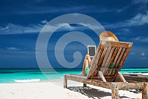 Young woman with tablet pc at the beach