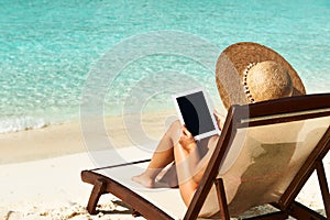 Young woman with tablet pc at the beach