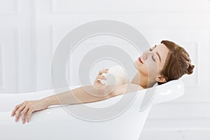 Young woman take a bath in bathtub