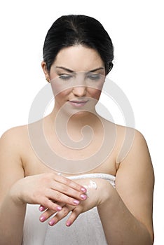 Young woman take care of her hands with cream