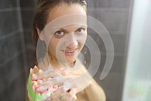 Young woman take hot shower after hard day, cleansing with washcloth