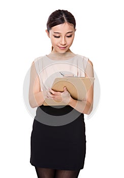 Young woman take note on clipboard