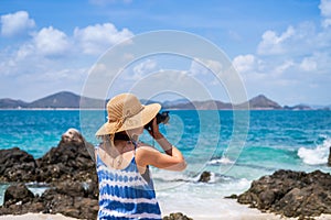 Young woman take a picture at the tropical beach, Summer vacation