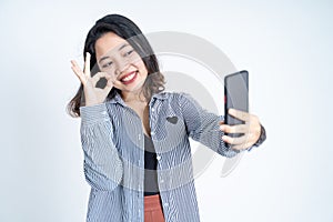 young woman take a selfie with ok hands gesture