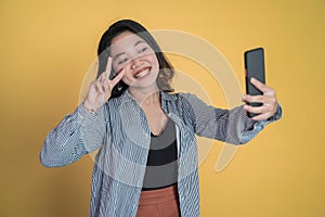 young woman take a selfie with v sign finger gesture