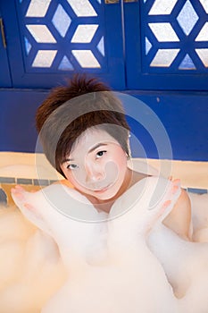 Young woman takes bubble bath