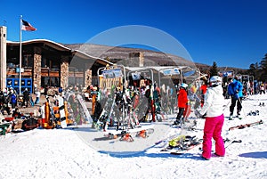 A young woman takes off her skis for a break