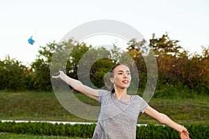 Young woman takes off medical mask standing outdoor.