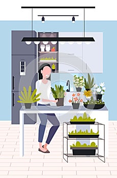 Young woman taking care of houseplants girl enjoying her ecology hobby stay home lifestyle concept