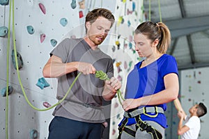 Young woman taking climbing lessons