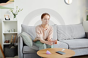 Young Woman Taking Pain Medication