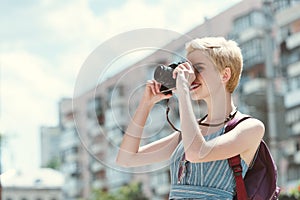 young woman taking photo on camera