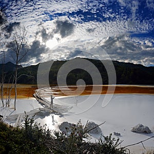 young woman taking photos of red polluted lake in Romania, Alba, Geamana photo