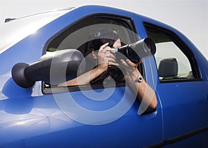 Young woman taking photos with telephoto lens