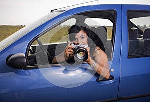 Young woman taking photos with telephoto lens